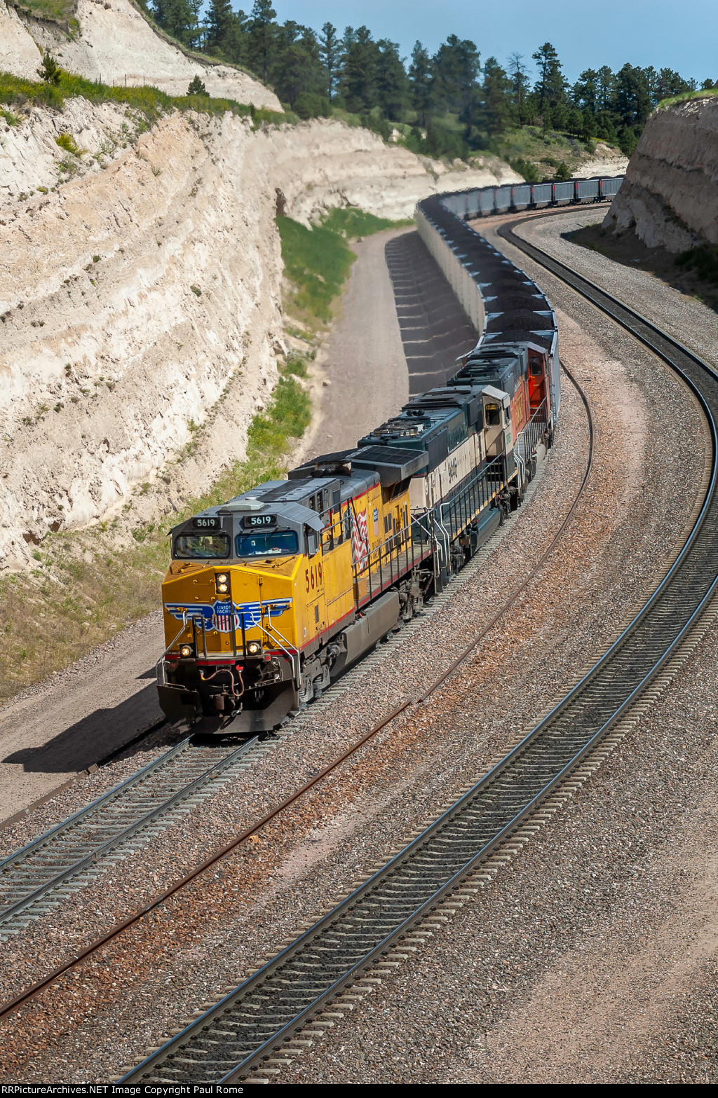 UP 5619 and BNSF 9446 and 9480 power the eastbound Jefferies Energy coal train snaking its way over the summit of Crawford Hill